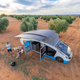 The solar-powered campervan is set up to charge with its roof extended to show its solar tiles